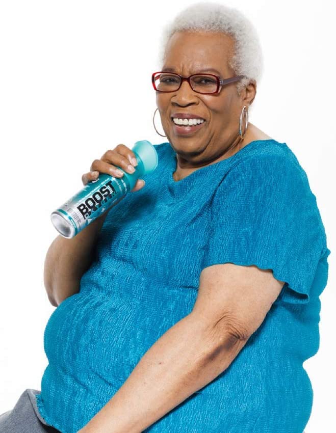 Photo of an elderly woman about to inhale from a canister of Boost oxygen.