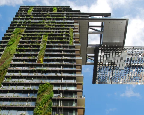 A photo of a highrise building covered in hanging gardens, with plants installed on the sides at, One Central Park Sydney.