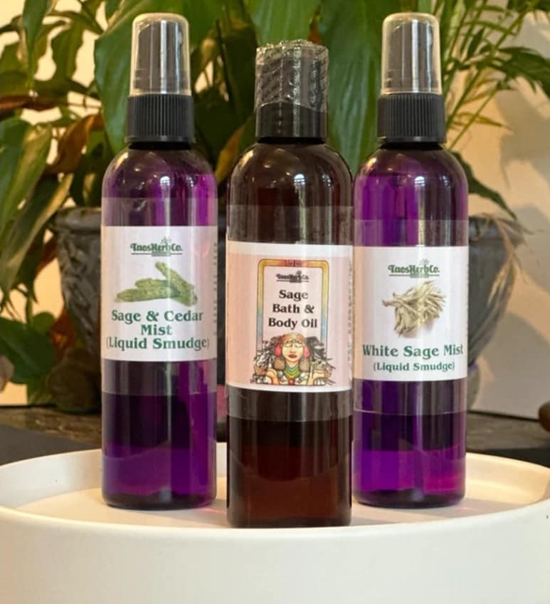 Close-up photo of Bottles of naturally scented bath and body oils, liquid smudge, and smudge mist.